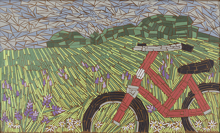 Cut paper arranged to form a red bicycle. Rolling hills in background.